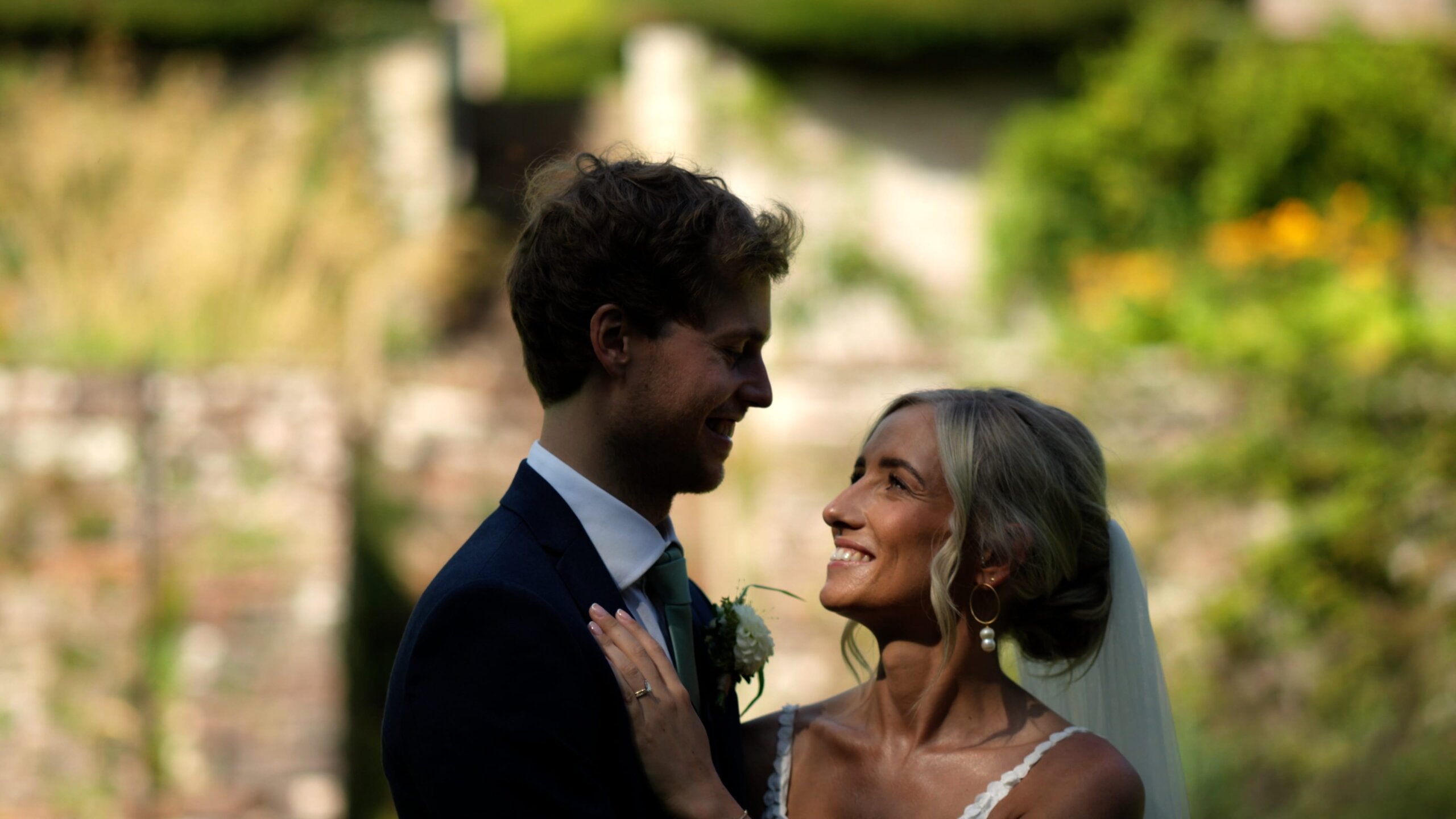 Manchester Wedding Videographer, Homepage Title Image of a Wedding Couple Smiling at each other